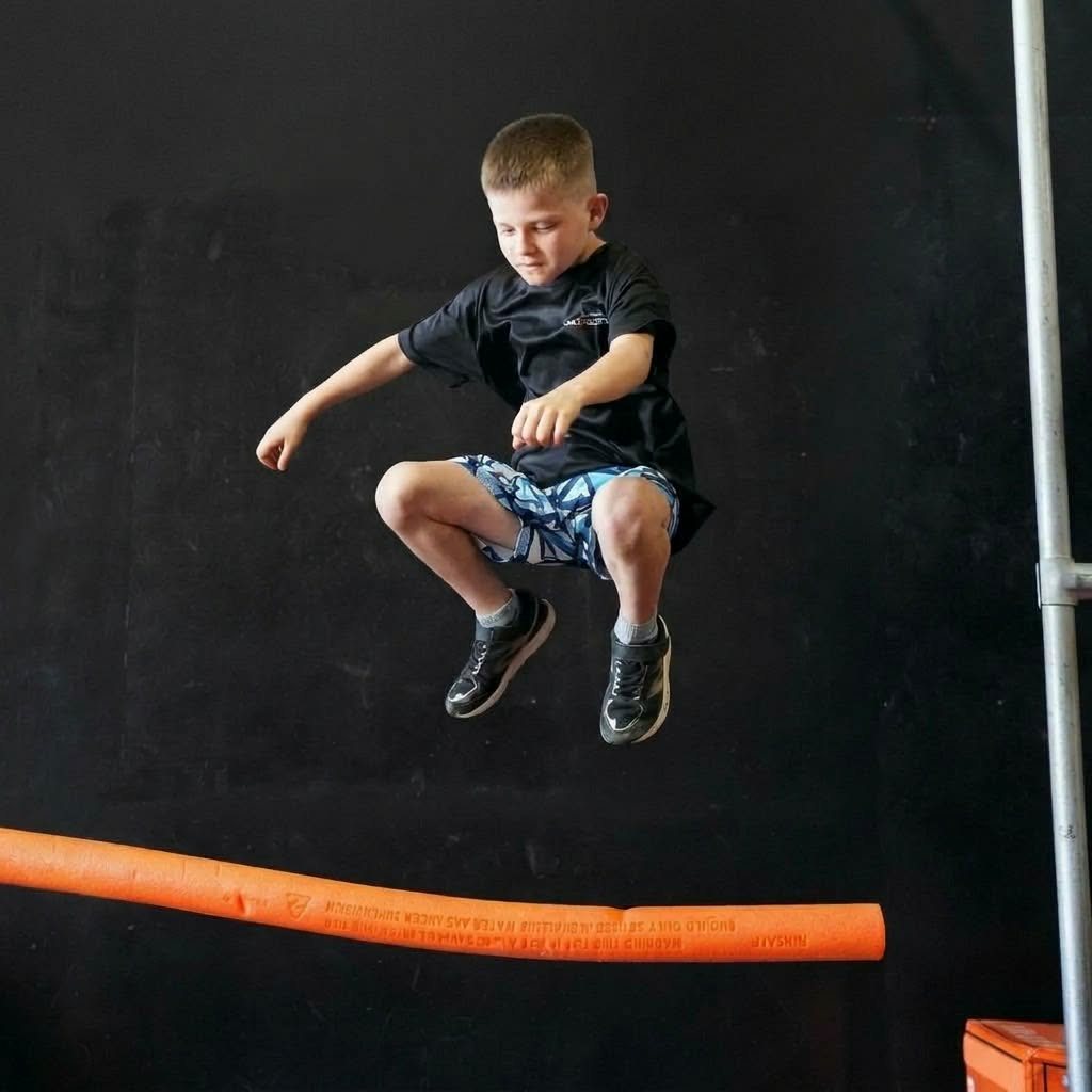 Boy jumping off an obstacle at an AWF party