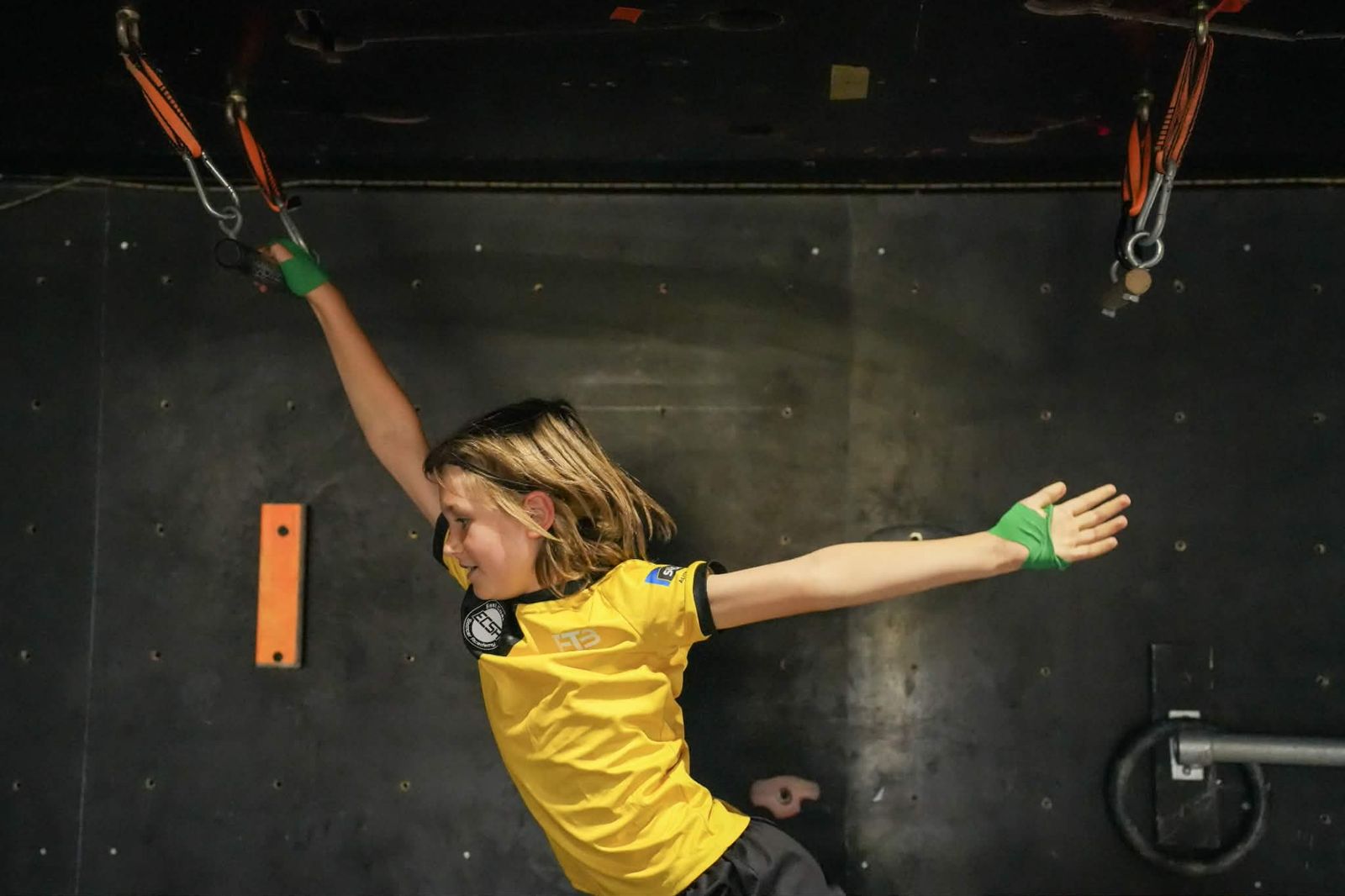 Kid swinging across ninja grips at AWF Gosford