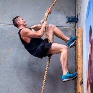 Cameron from Australian Warrior Fitness climbing wall with a rope