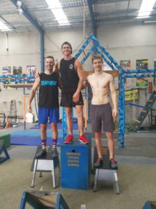 Cameron from Australian Warrior Fitness standing on podium with friends